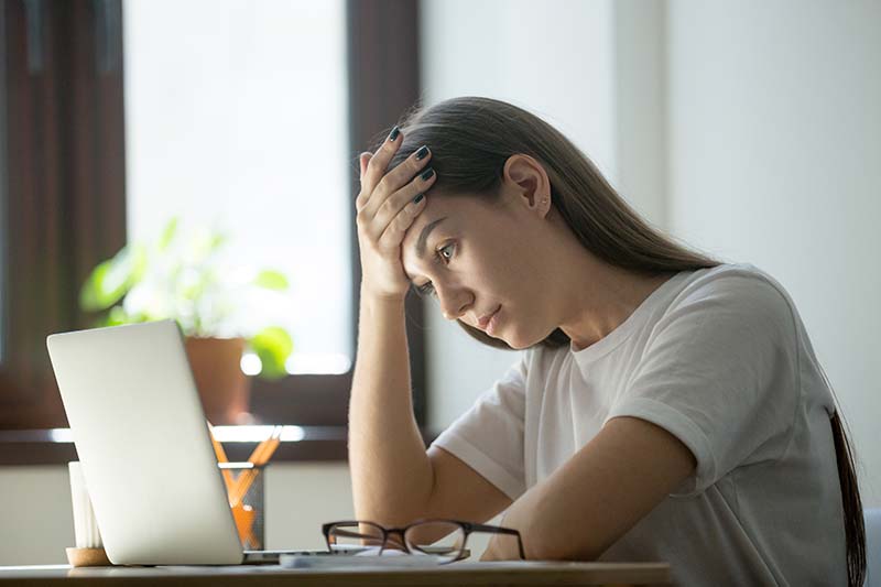 Overwhelmed student holding their head